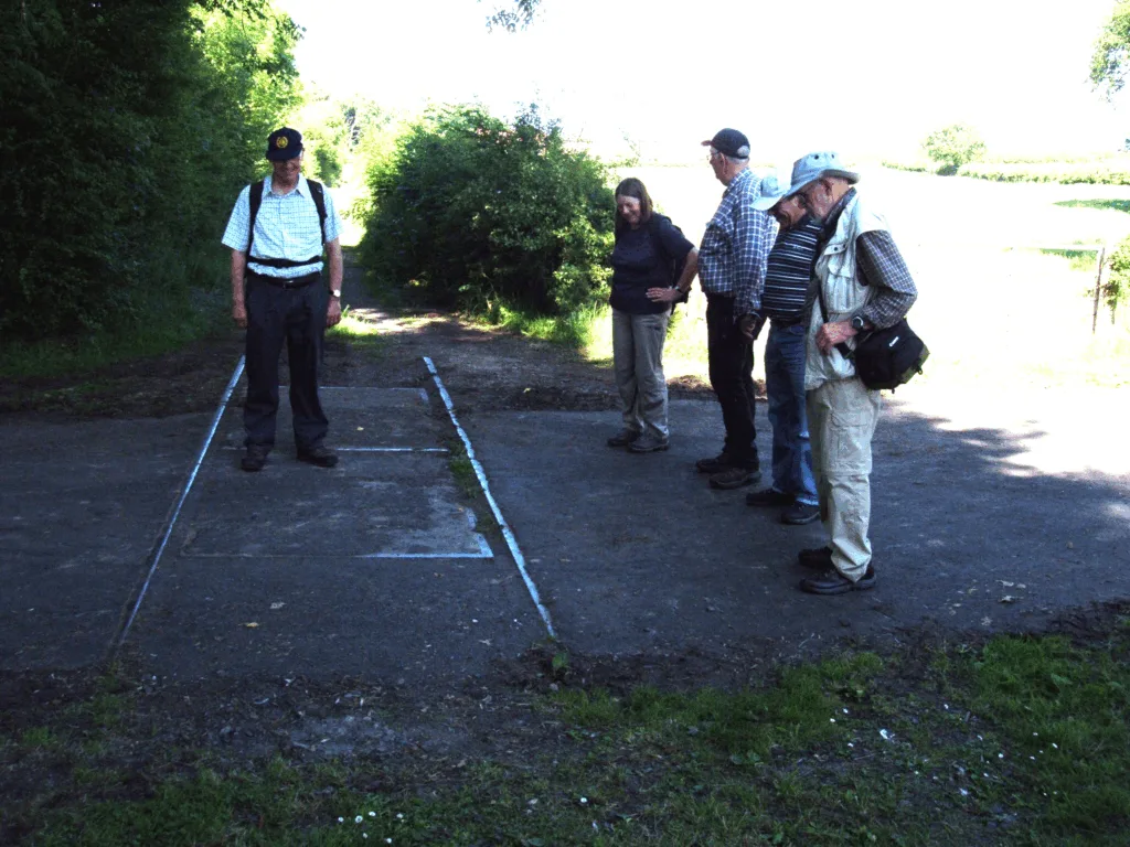 Field trip participants inspecting old railway tracks